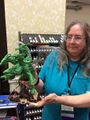 Julie in 2015 sculpting the massive popular Reaper Miniatures model "Ma'al Drakar, Dragon Tyrant" AKA "the best Tiamat model ever".